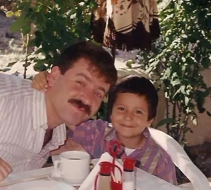 Emre as a young child with his father in Adrasan, Turkey, in the early 1990s